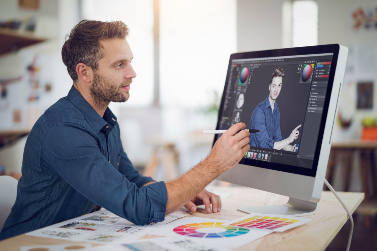 A designer laying out a brand palette on a desktop screen